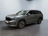 a grey suv parked in a showroom with a clock on the wall