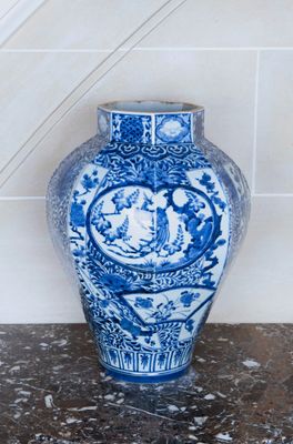 a blue and white vase sitting on top of a table