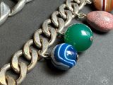 a silver chain with a bunch of different colored beads on it