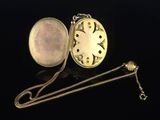 a gold locke with a chain around it on a black surface