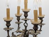 an image of a chandelier with five lit candles on a white background