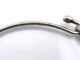 a picture of a silver bang bracelet with a bird on it