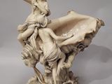 a statue of a woman sitting on a shell