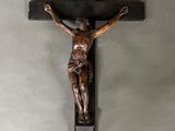 a statue of jesus on the cross hanging on a wall