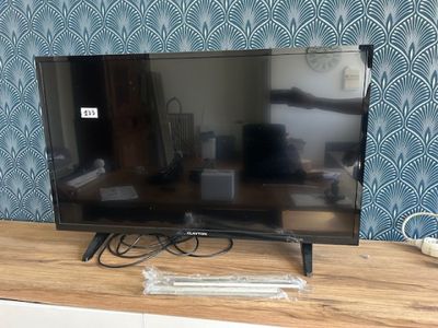 a flat screen tv sitting on top of a wooden table