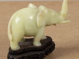 statue of an elephant on a wooden base on a table