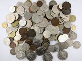 a pile of coins sitting on a white surface