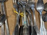 a lot of silver spoons and spoon spoons on a table