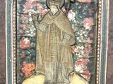 l'image d'un tableau représentant une figure religieuse, dans un cadre