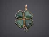 a gold and jade four leaf clover pendant