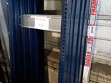 a stack of metal shelves in a warehouse with boxes