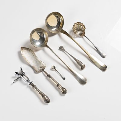 five spoons and two spoon spoons on a white surface