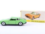 an image of a green toy car next to a box of matches