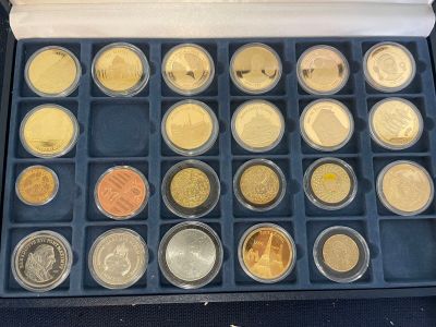 a lot of different coins in a box on the table
