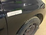 a black car with a sticker on the side of it