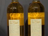 two bottles of wine that are sitting on a table