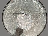 a glass bowl with a spoon in it on a table