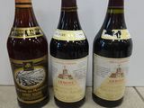 three bottles of wine sitting on a counter top next to each other