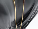 a gold chain on a mannequin head