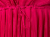 a close up of a red dress with pleas on it