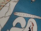 a plate with a giraffe on it and a woman sitting in a rocking chair