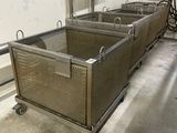 four metal bins in the middle of a room