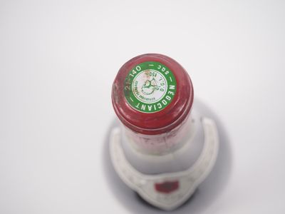 gros plan d'une bouteille de vin sur une surface blanche