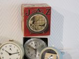 three clocks sitting next to each other on a table
