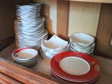 many plates and bowls stacked on top of each other