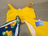 yellow and blue swimsuits with oranges on them on the floor