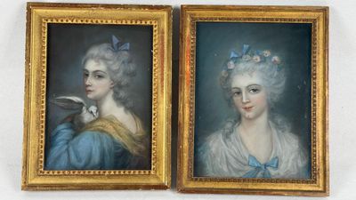 two framed portraits of women in blue dresses with a bird on her shoulder