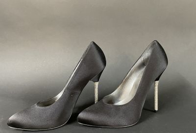 pair of women ' s grey high heeled shoes on a gray background
