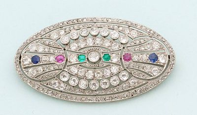 an image of a diamond and sapphire broochle on a white background