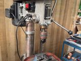 a drill on a table in a workshop with a number 24 on it
