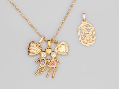 a close up of a necklace and a pendant on a table