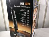 the box is open on the table with the vacuum in it