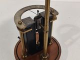 a small clock that is on top of a wooden stand