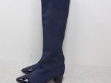 a close up of a pair of blue boots on a white surface