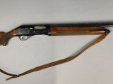a rifle that is laying on a white surface