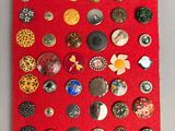 a red piece of fabric covered with buttons and buttons