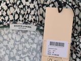 the back of a black and white dress with a price tag on it
