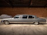 a car that is parked in a garage next to a bed