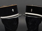 pair of black and white hats sitting on top of a black mannequin head