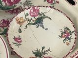 a tray with plates and bowls on it on a table