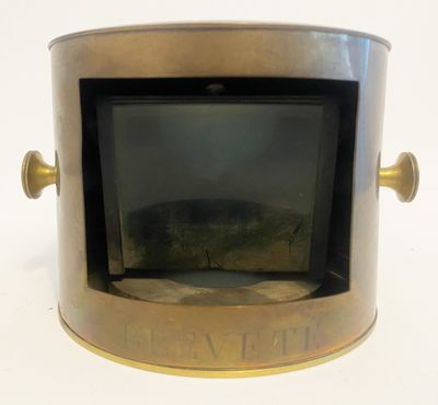 a small metal box with a picture inside of it