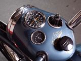 a close up of a motorcycle with a clock on the handlebars
