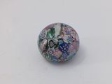 a close up of a glass bead on a white surface