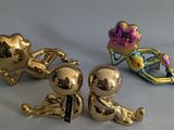 three gold figurines sitting next to each other on a table