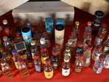 many bottles of alcohol sitting on a red table