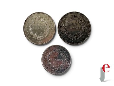 trois types de pièces différents posés sur une surface blanche